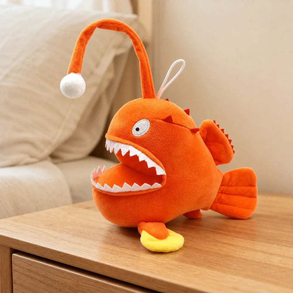 Cartoon Orange Anglerfish Plush Toy on a Bedside Table