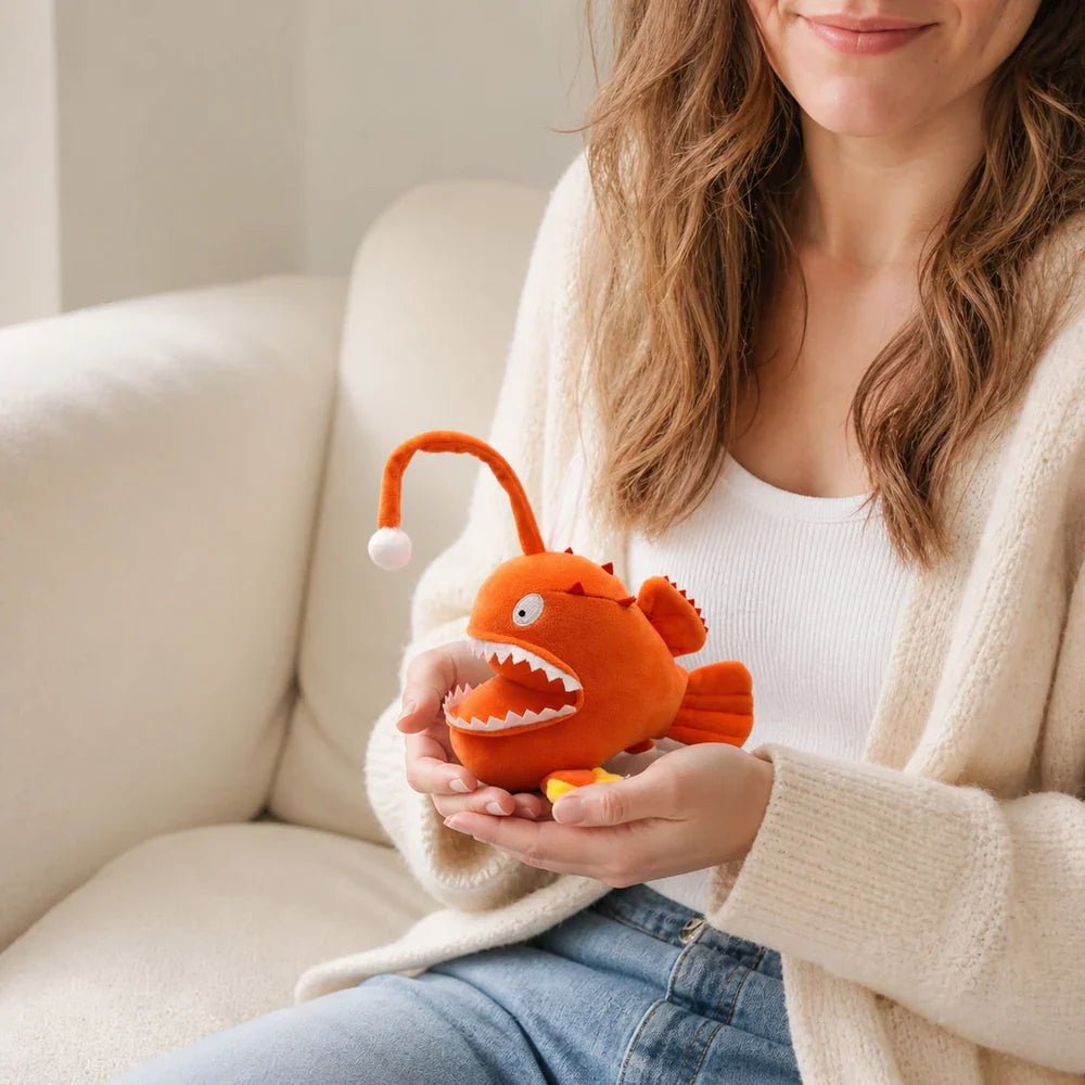 Cartoon Orange Anglerfish Plush Toy Held in Hands