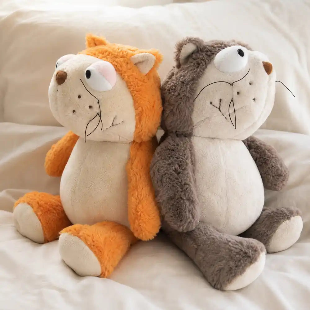 Gray and Orange Otter Plush Stuffed Animals on a Cozy Bed