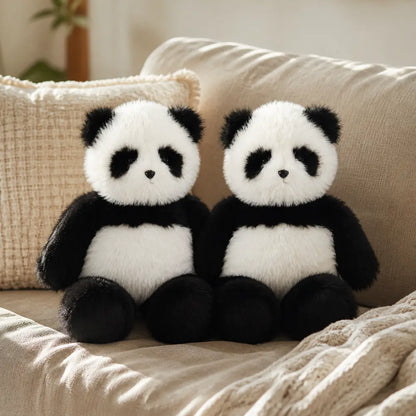 Two Giant Fuzzy Panda Plush Toys on a Sofa