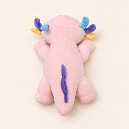 Overhead back view of the Pastel Gills axolotl plush showing smooth pink fabric, colorful gills, and a purple fin.