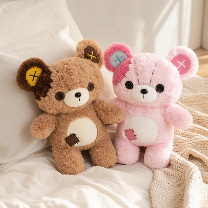 Tan and Pink Patchwork Teddy Bear Plush Pair on an Ivory Bed