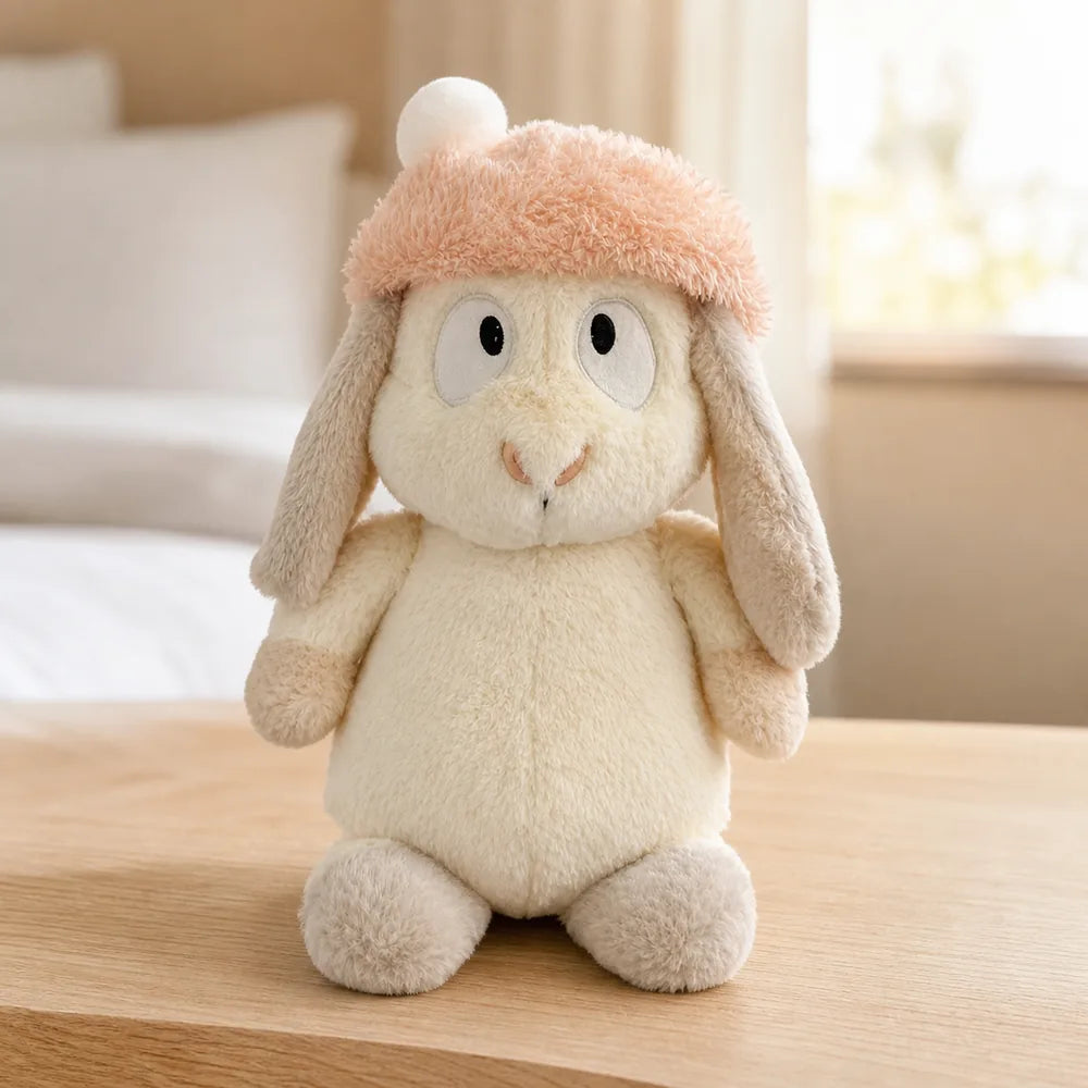 Peach Pom-Pom Bunny Plush - On a Light Oak Table