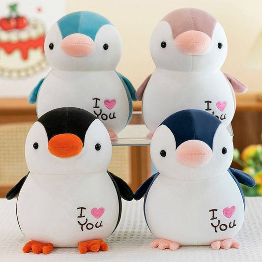 Four penguin plush pillows in different colors