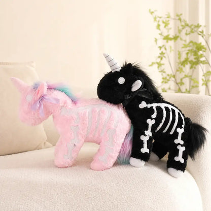 Pink and Black Skeleton Unicorn Plushes on a Cream Sofa