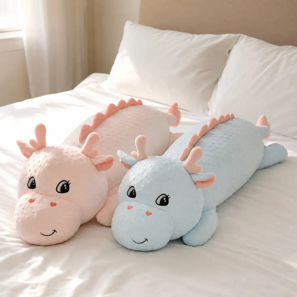Pink and Blue Long Dinosaur Plush Toys on a Bed