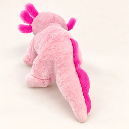 Rear view of the pink axolotl stuffed animal showing its long tail and bright pink tail fin.