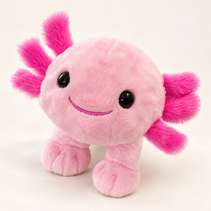 Front view of a pink axolotl stuffed animal with bright pink gills, glossy black eyes, and an embroidered smile.