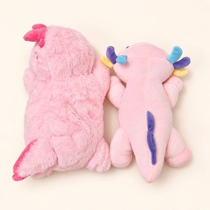 Back view of two pink axolotl plush styles side by side, showing their different fabrics and tail fins.