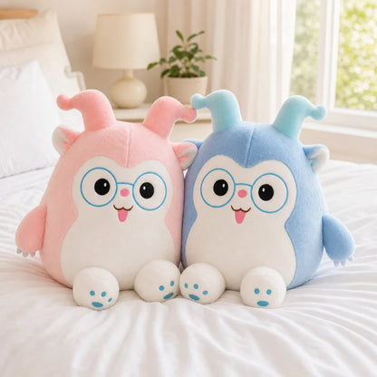 Pink and Blue Glasses Plush Toys Together on a Cozy Bed