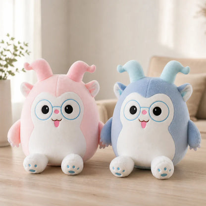 Pink and Blue Glasses Plush Toys on a Light Wood Table