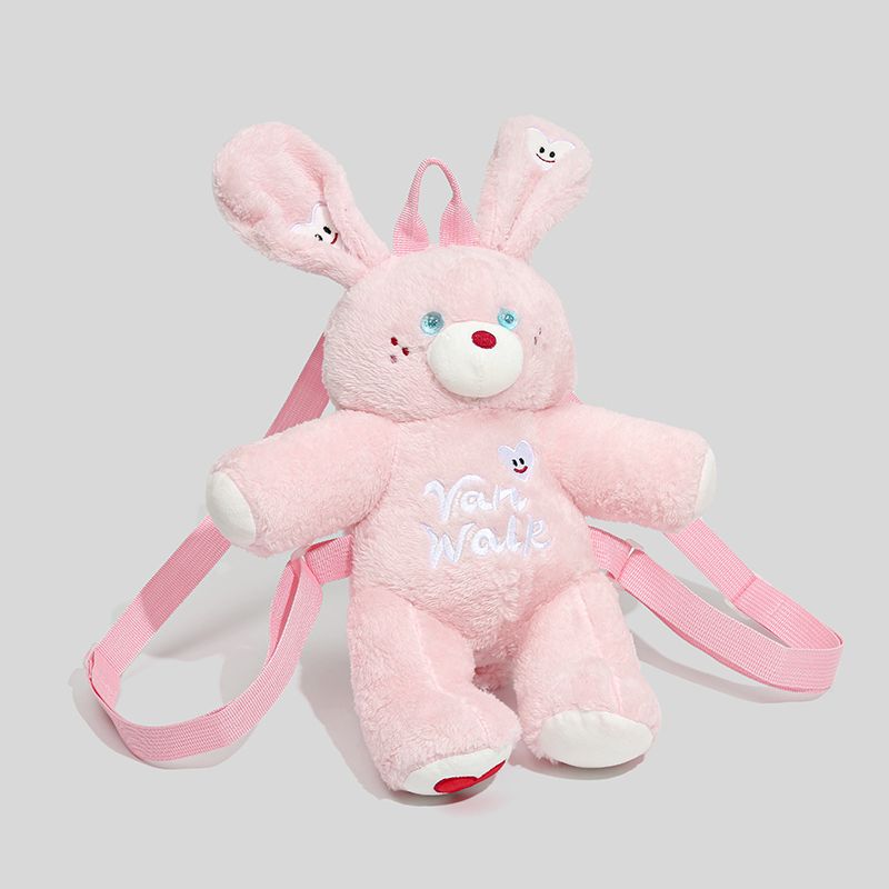 Pink bunny plush backpack with cute ears and a heart-shaped patch, perfect for kids