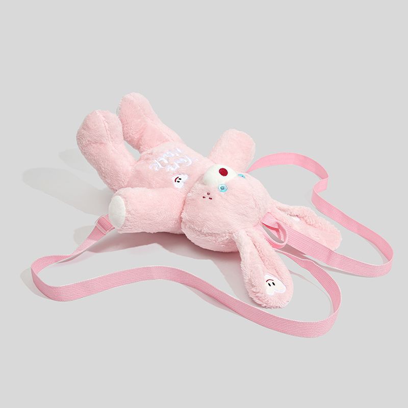 Pink bunny plush backpack with cute ears and a heart-shaped patch, perfect for kids