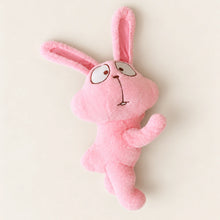 Overhead view of the pink bunny plush with long ears and small arms and feet.