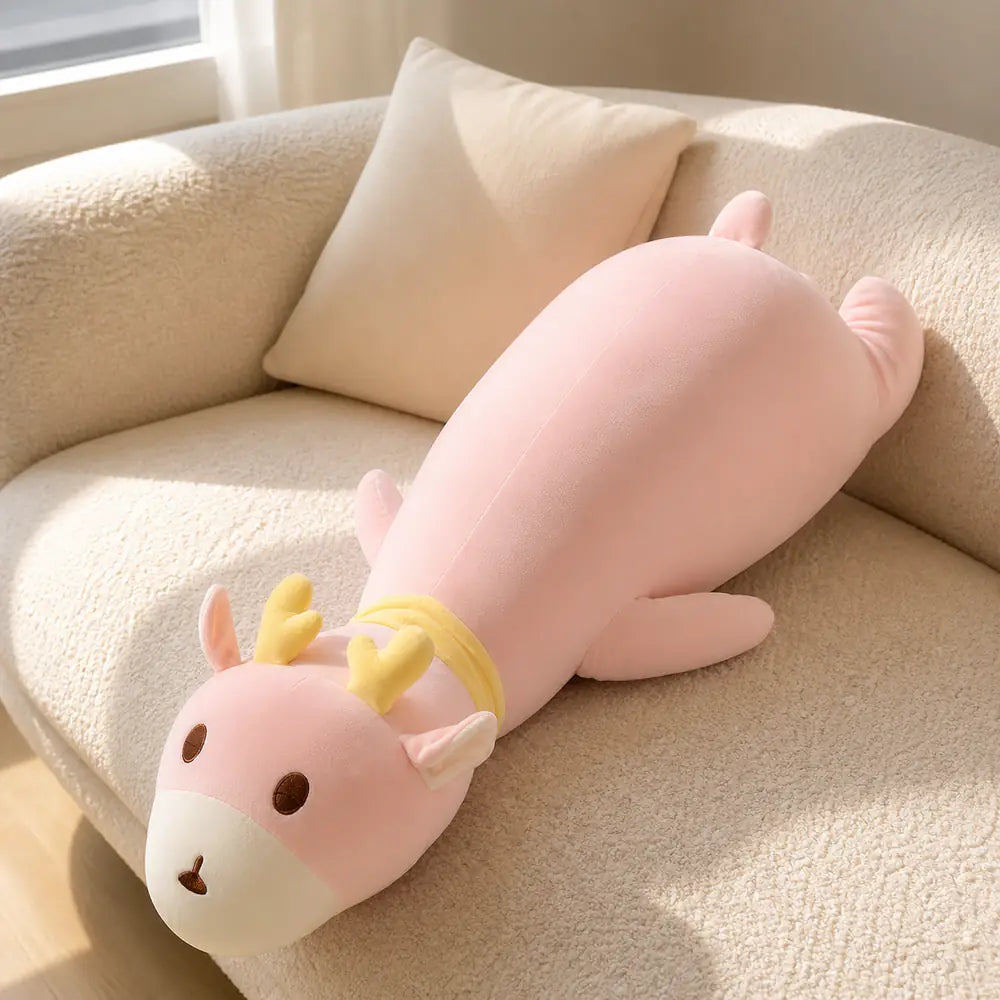 Pink Long Deer Body Pillow Plush on a Cream Sofa