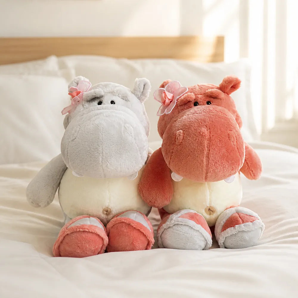 Pink and Gray Flower Hippo Plush on a Cozy Bed
