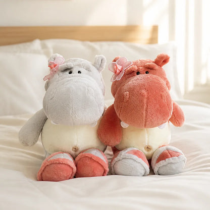 Pink and Gray Flower Hippo Plush on a Cozy Bed