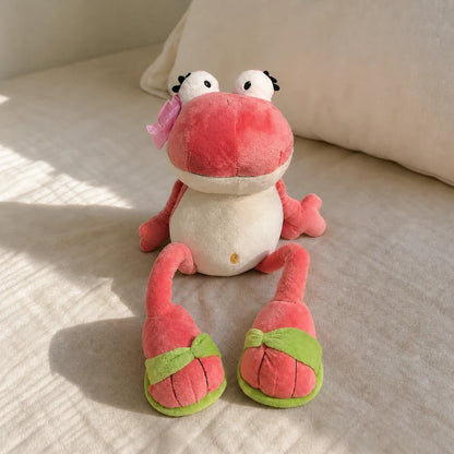 Pink Frog Plush Toy on a Linen Bed