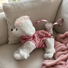 Pink Sequin Poodle Plush Bag on a Cream Sofa