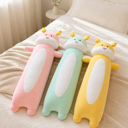 Pink Mint Green and Yellow Long Dragon Plush Toys on a Bed