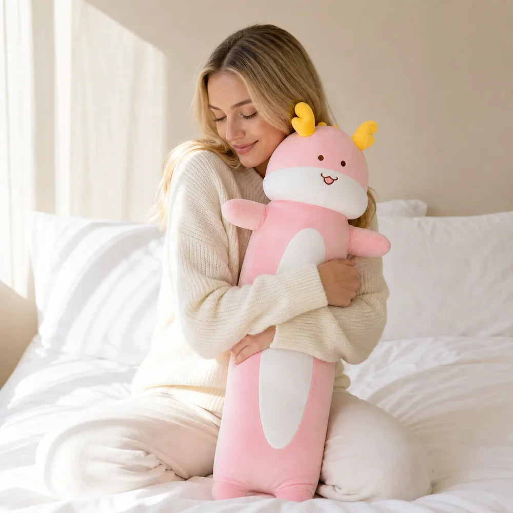 Woman Hugging a Pink Long Dragon Plush on a Bed