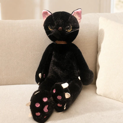 Black Scowling Cat Plush on a Cream Sofa