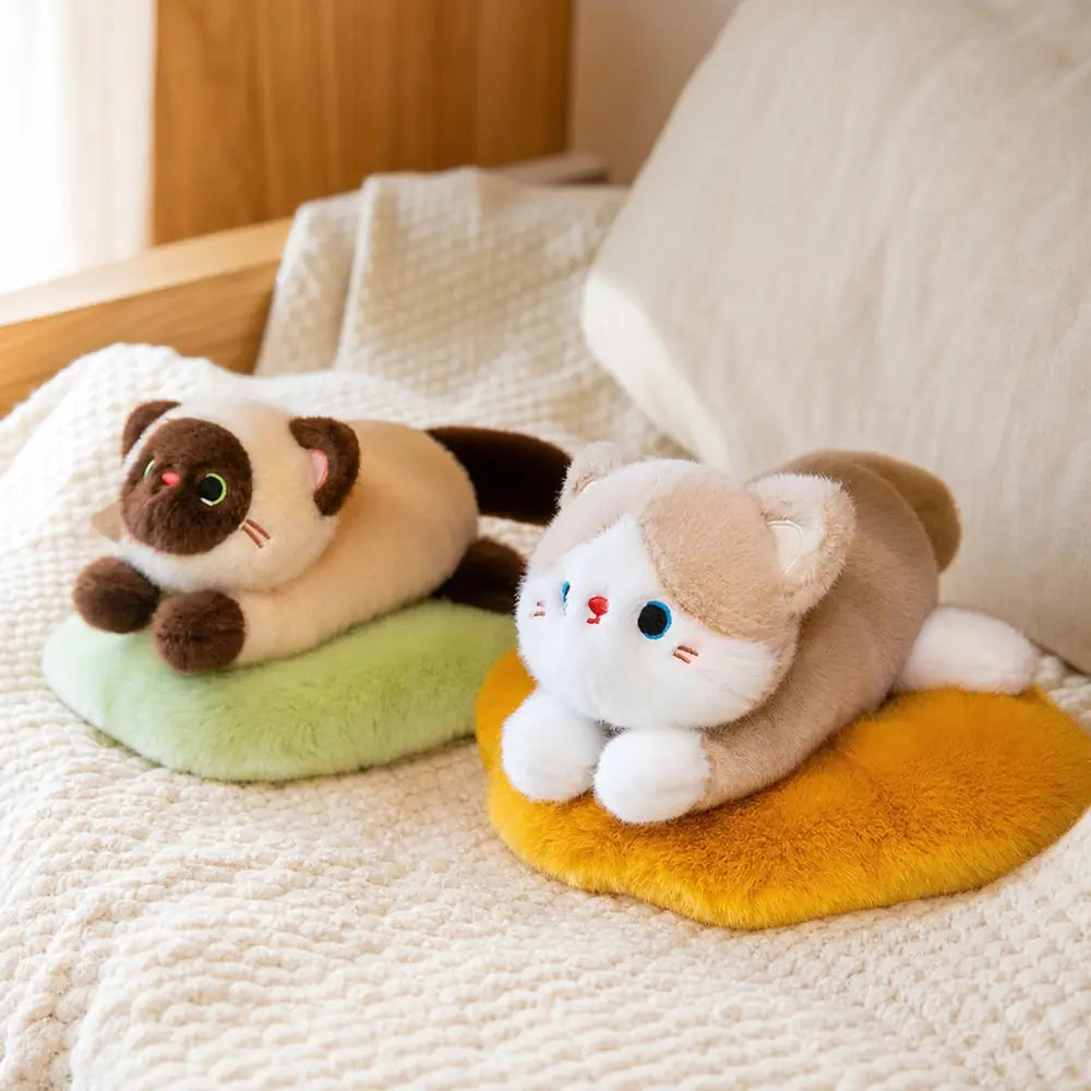 Siamese and Cream Cat Plush Pillows on a Bed