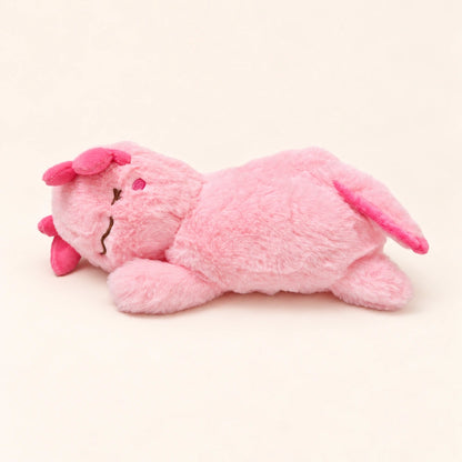 Side view of the Sleepy Pink axolotl plush showing fluffy pink fabric, embroidered facial details, and a pink tail fin.