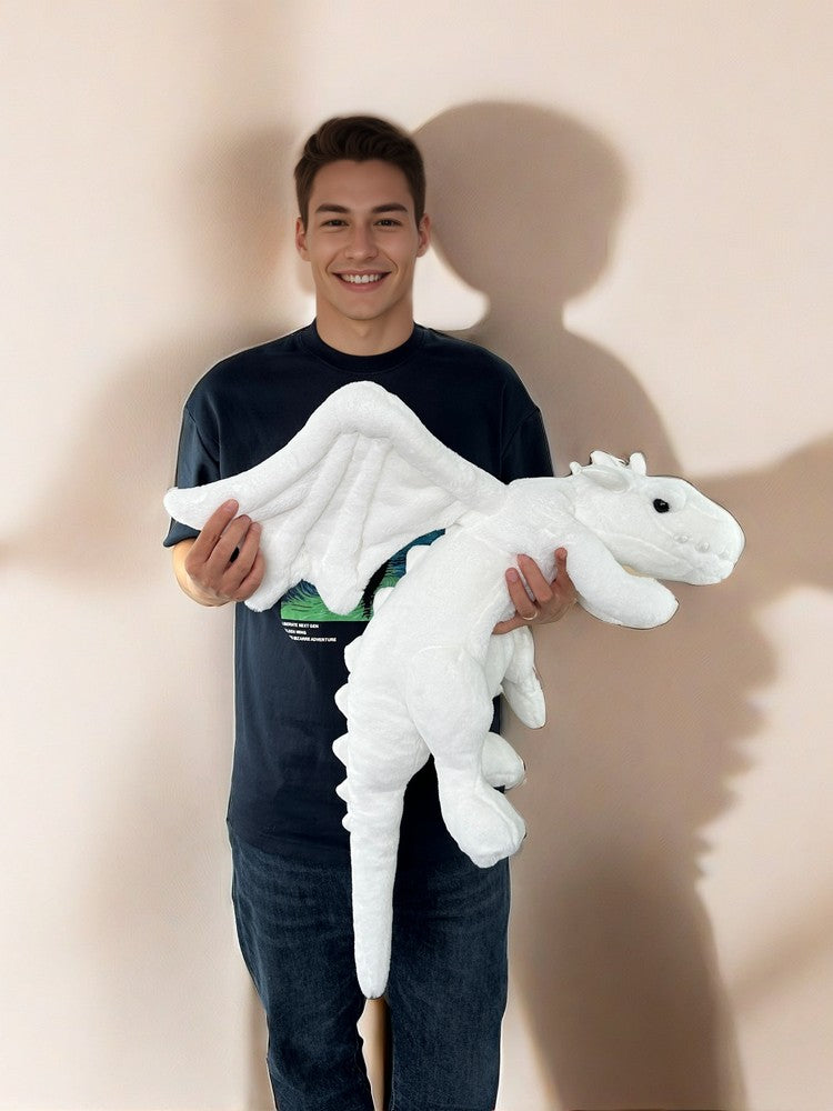 a guy holds a PlushThis snow dragon plush