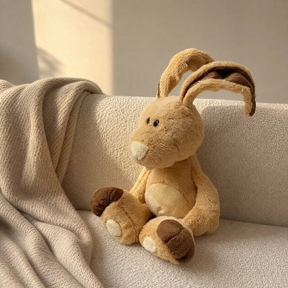 Tan Bunny Plush Toy on Cream Sofa
