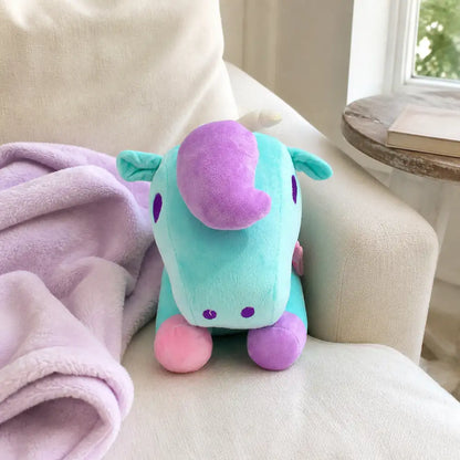 Turquoise pastel unicorn plush toy on a sunlit chair
