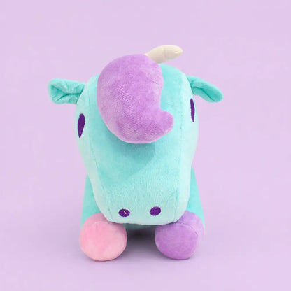 Turquoise pastel unicorn plush toy front view on a lavender studio background