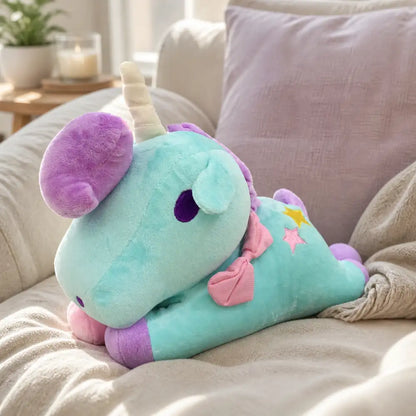 Turquoise pastel unicorn plush toy on a cozy sofa