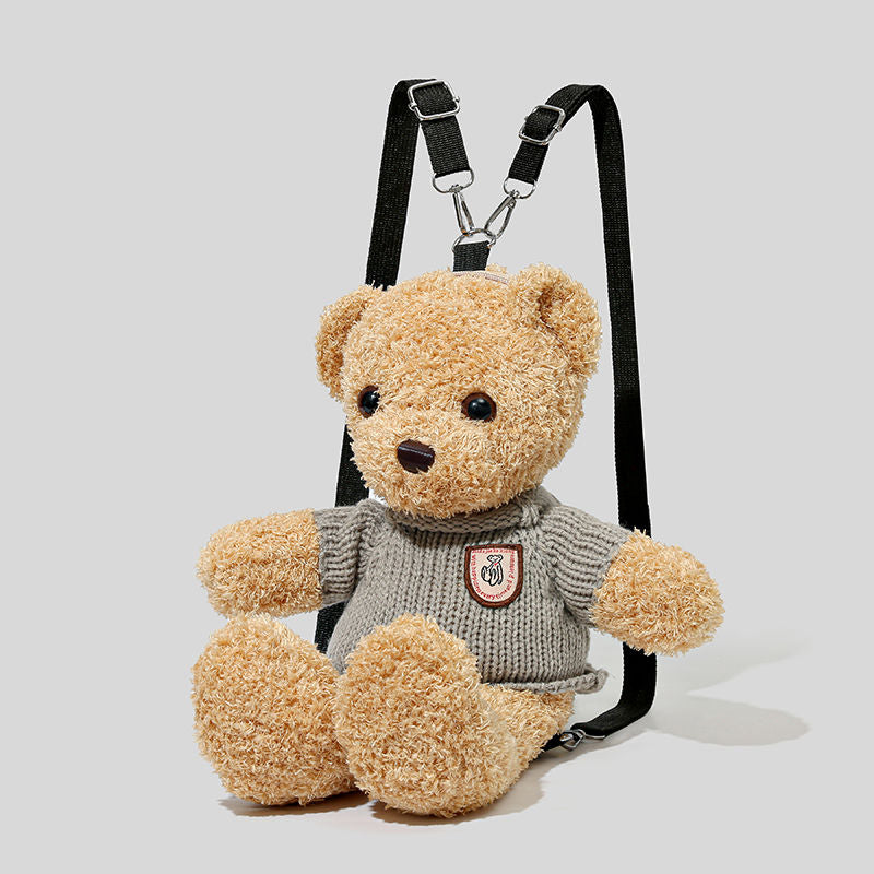 Brown teddy bear backpack wearing a knitted jumper