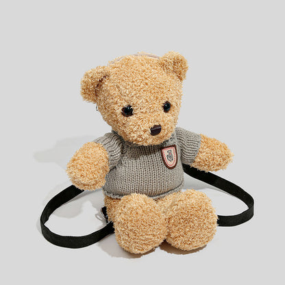 Brown teddy bear backpack wearing a knitted jumper