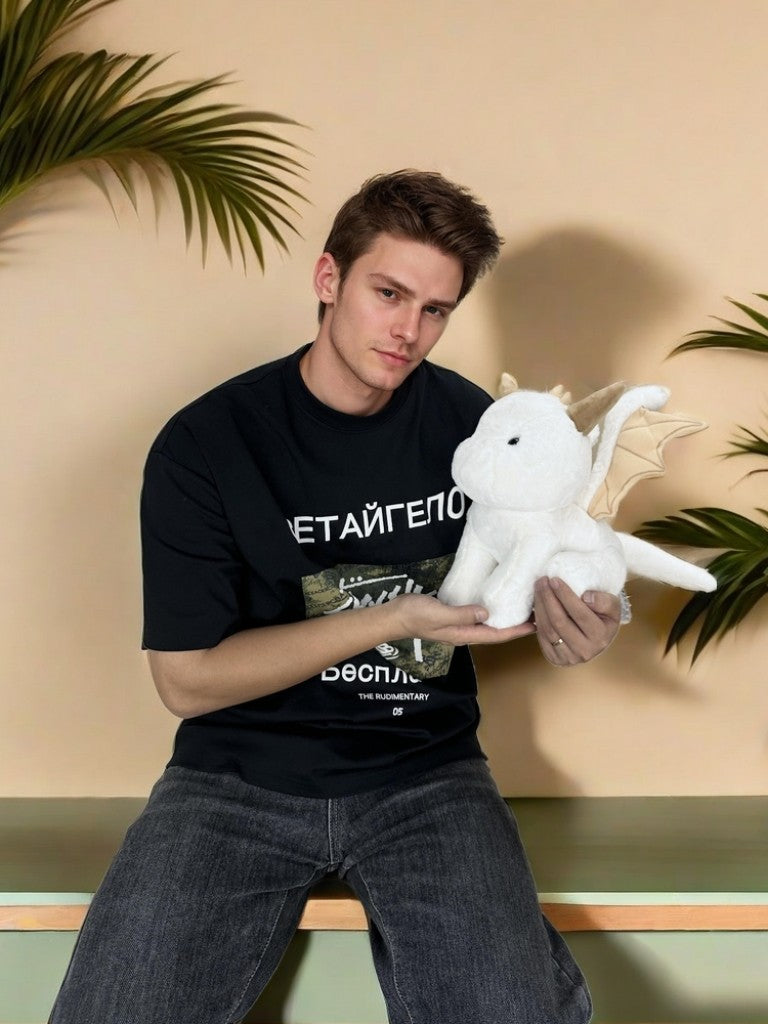 a guy hold a PlushThis dragon plush 