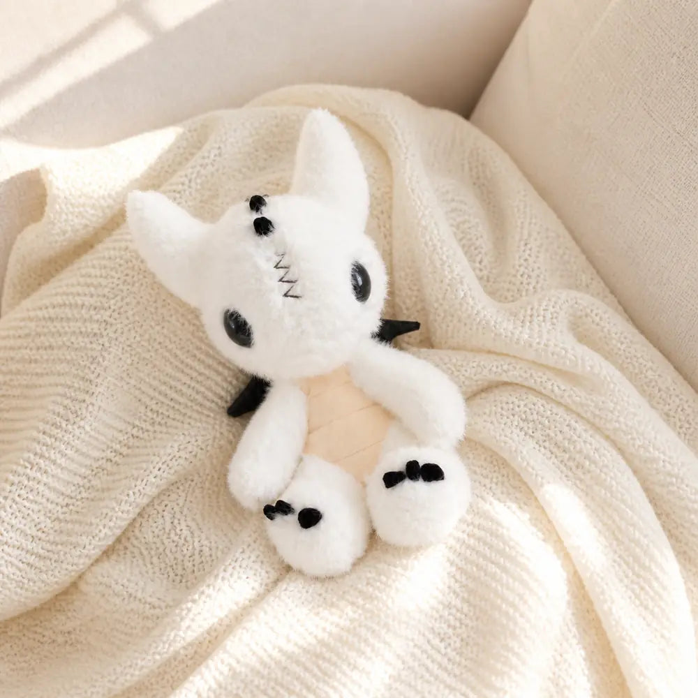 White Dragon Plush 23cm on a Cozy Knit Throw
